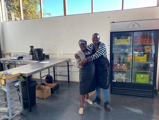 Flora and Tebogo in the original Green Roots Juicery, June 2022